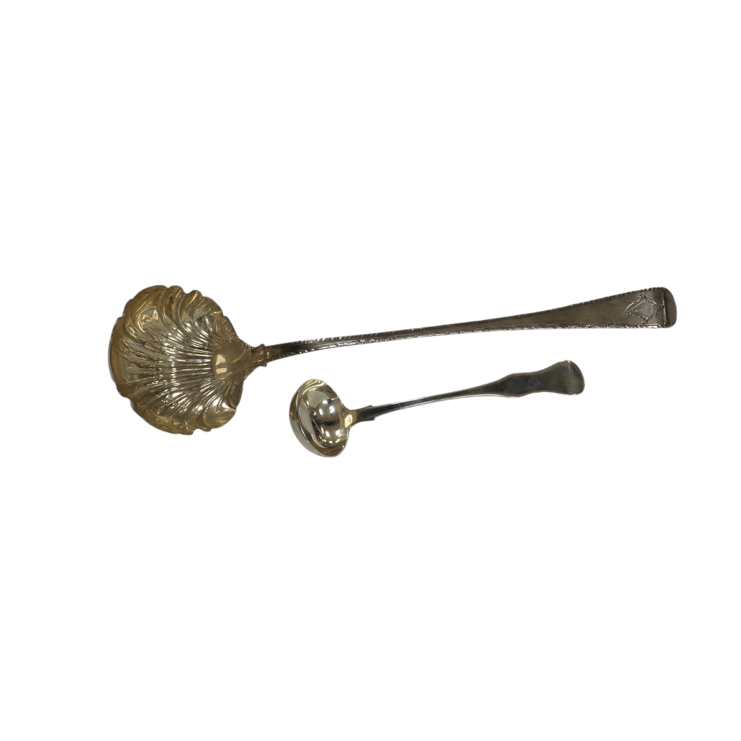 An early George III silver Old English feather edge pattern soup ladle, George Baskerville, London, 1766, together with a Victorian Scottish silver sauce ladle, 6.1 oz. Condition - poor to fair